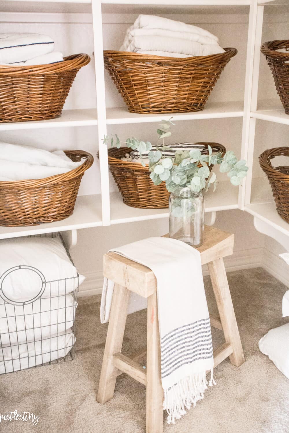 Linen closet with basket used for organization