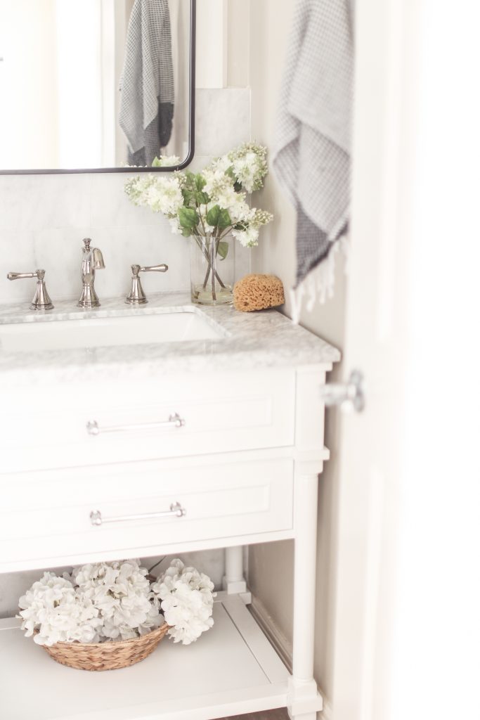 Bathroom faucet in white bathroom 