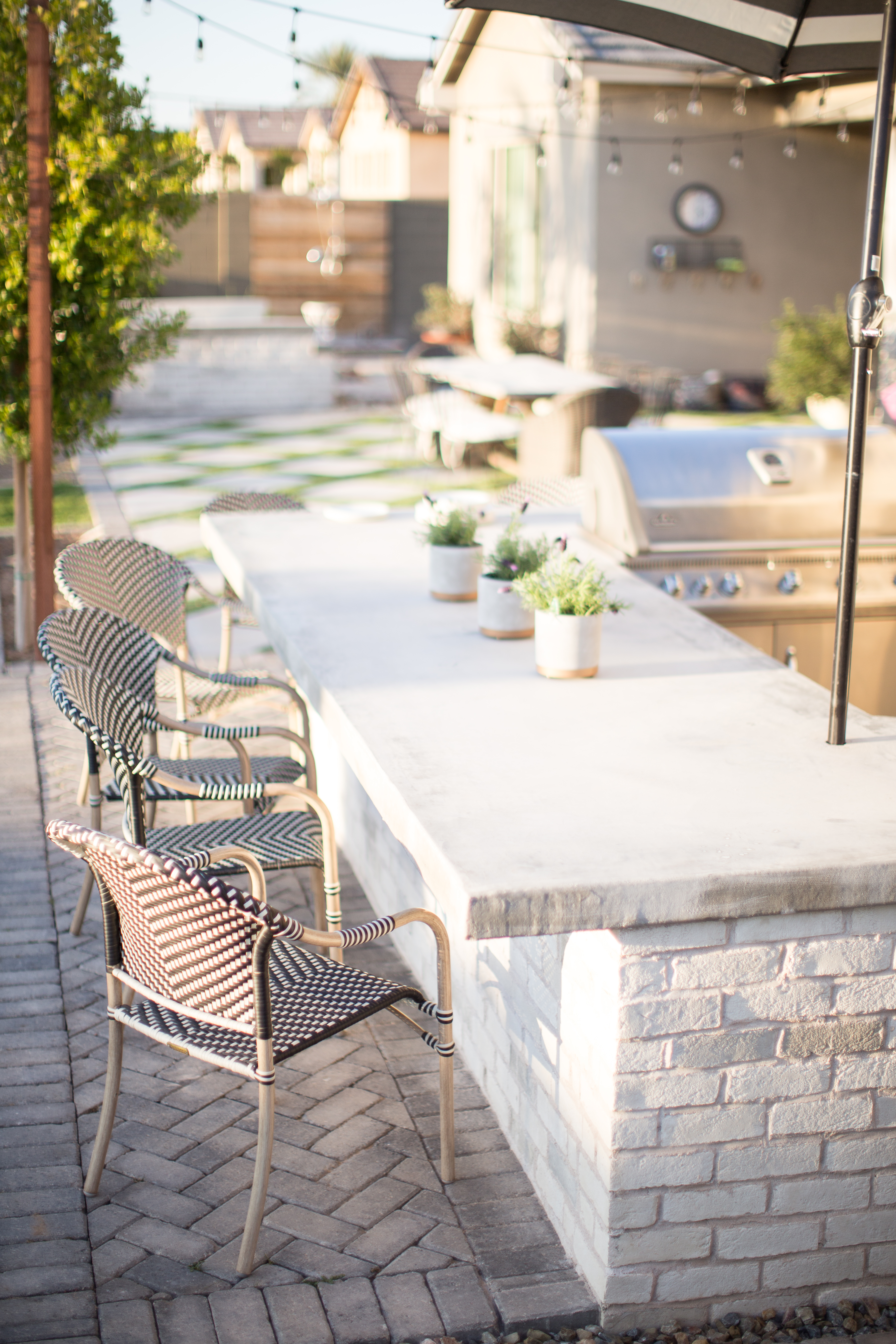 White Brick Outdoor Kitchen With Concrete Countertop Design Ideas