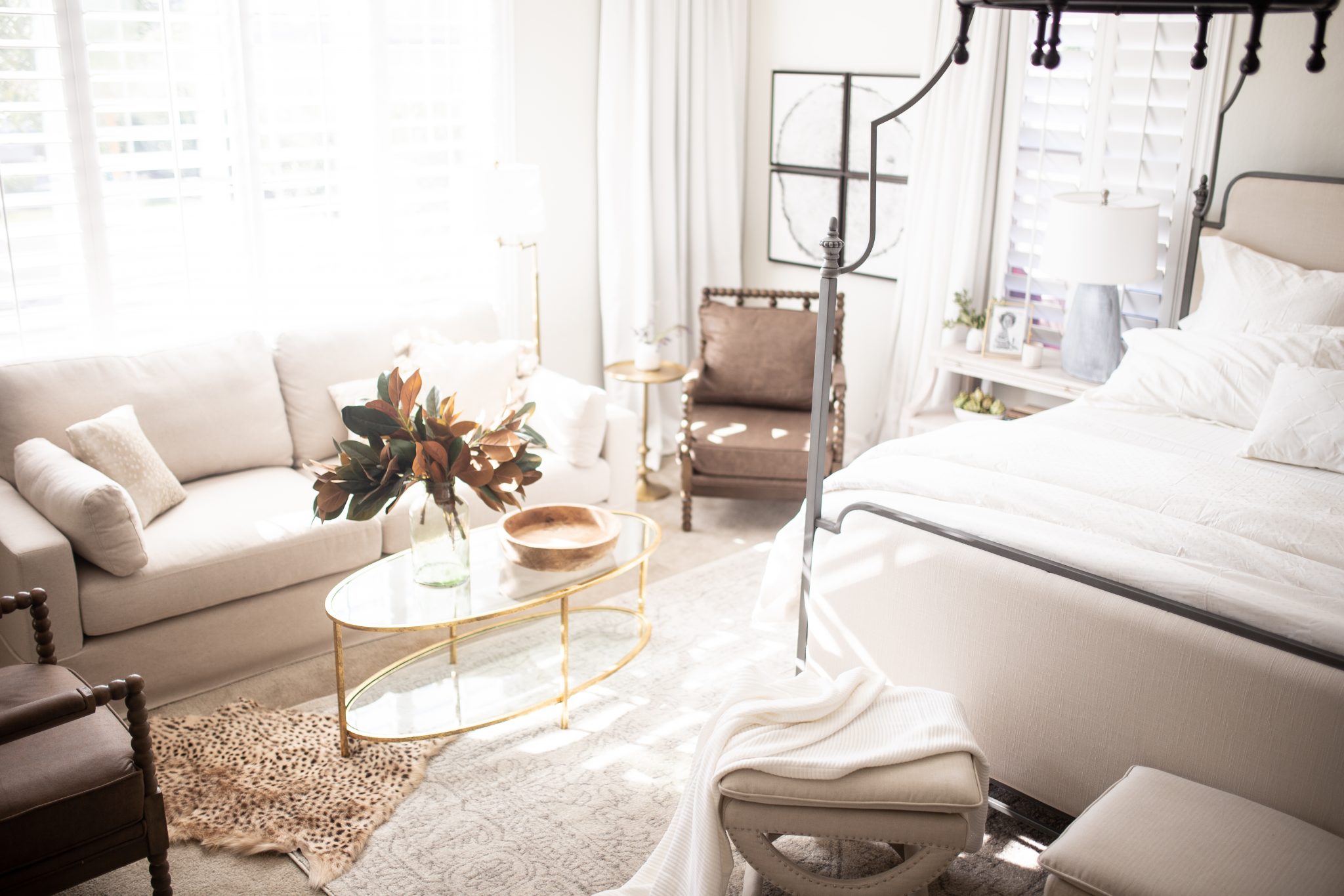 Nuetral Bedroom with Gold leaf Coffee table, sofa and corner of the bed. 