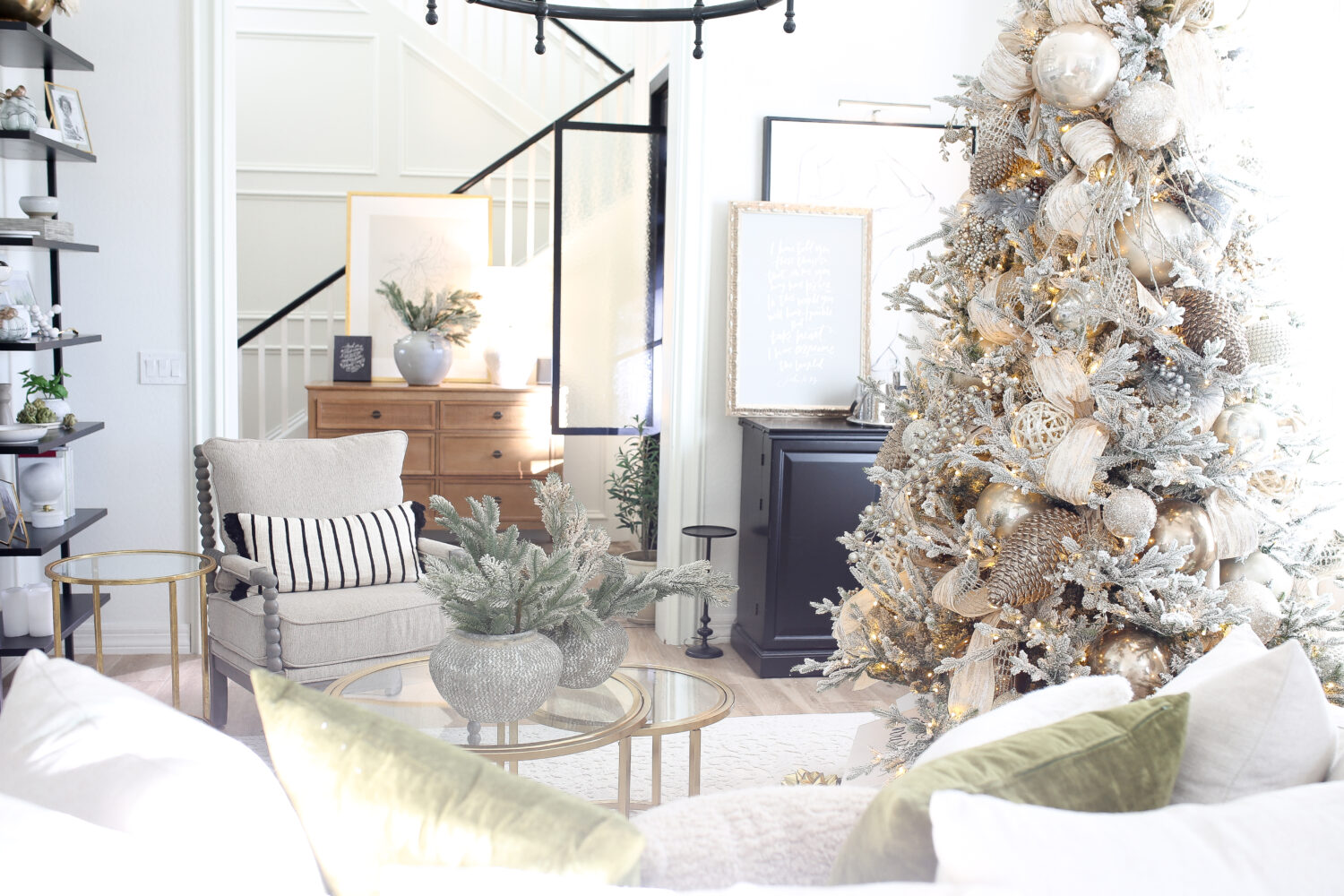 Christmas tree in a nuetral room. The tree is decorated with beautiful decor in gold, silver and white. 