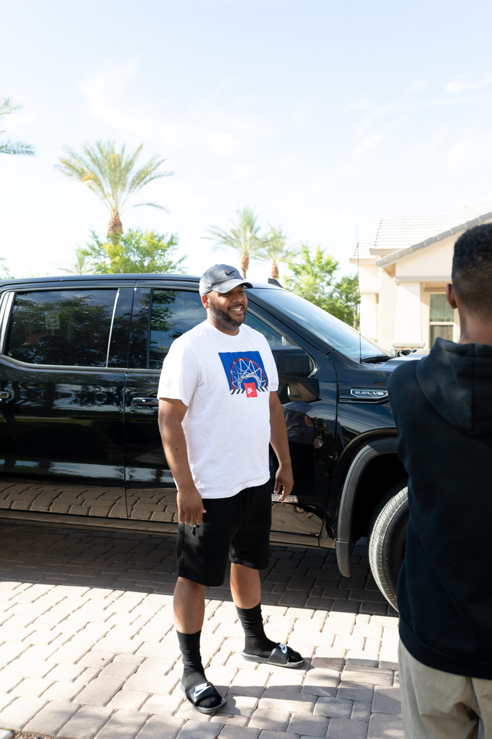 Dad in front of black GMC truck