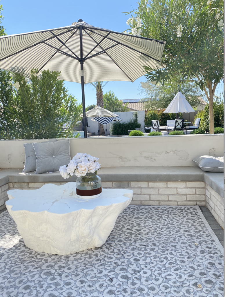 All white outdoor table that looks like a tree trunk. This table is from Serena and Lily 