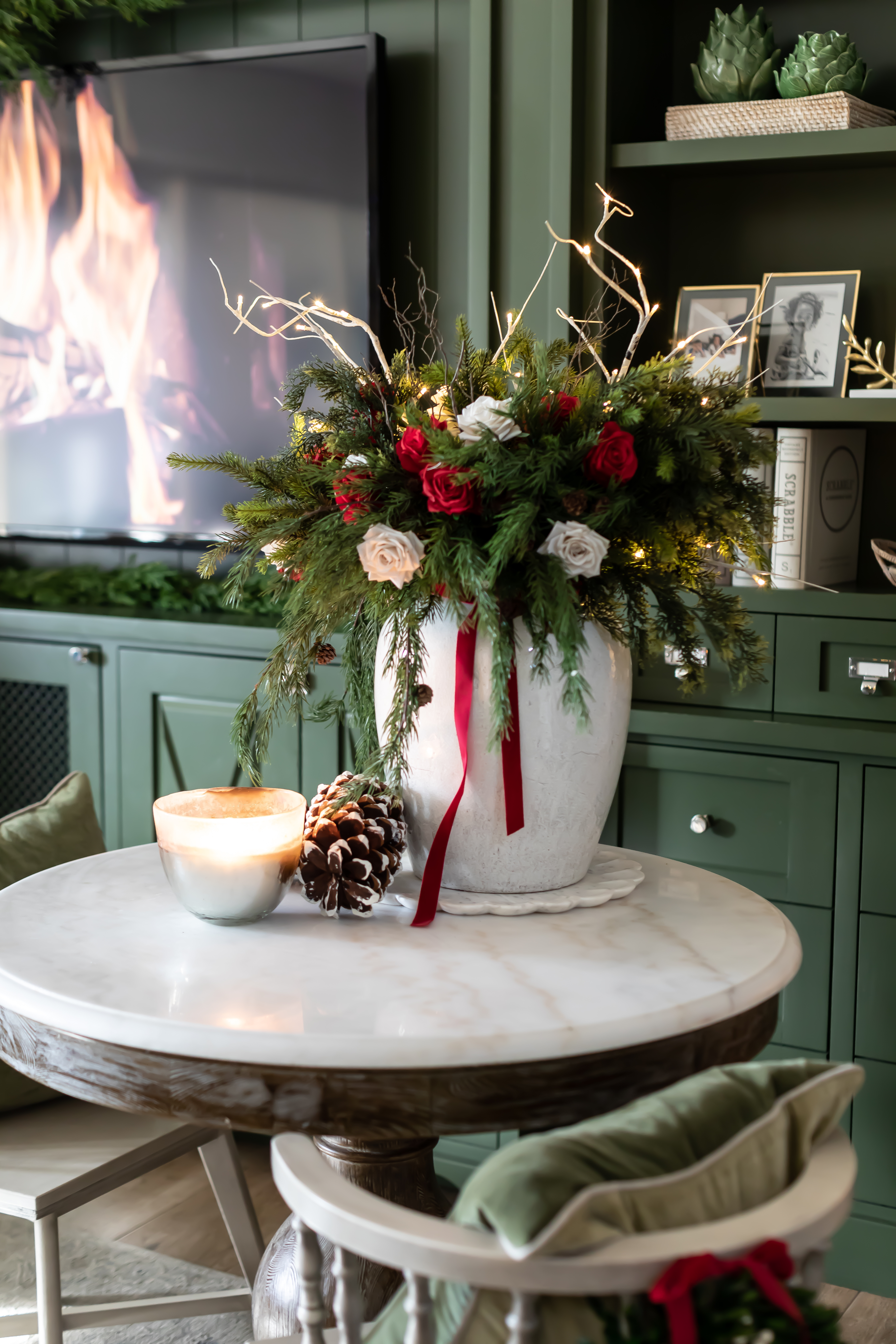 Arhaus round marble table with red Christmas decor. 