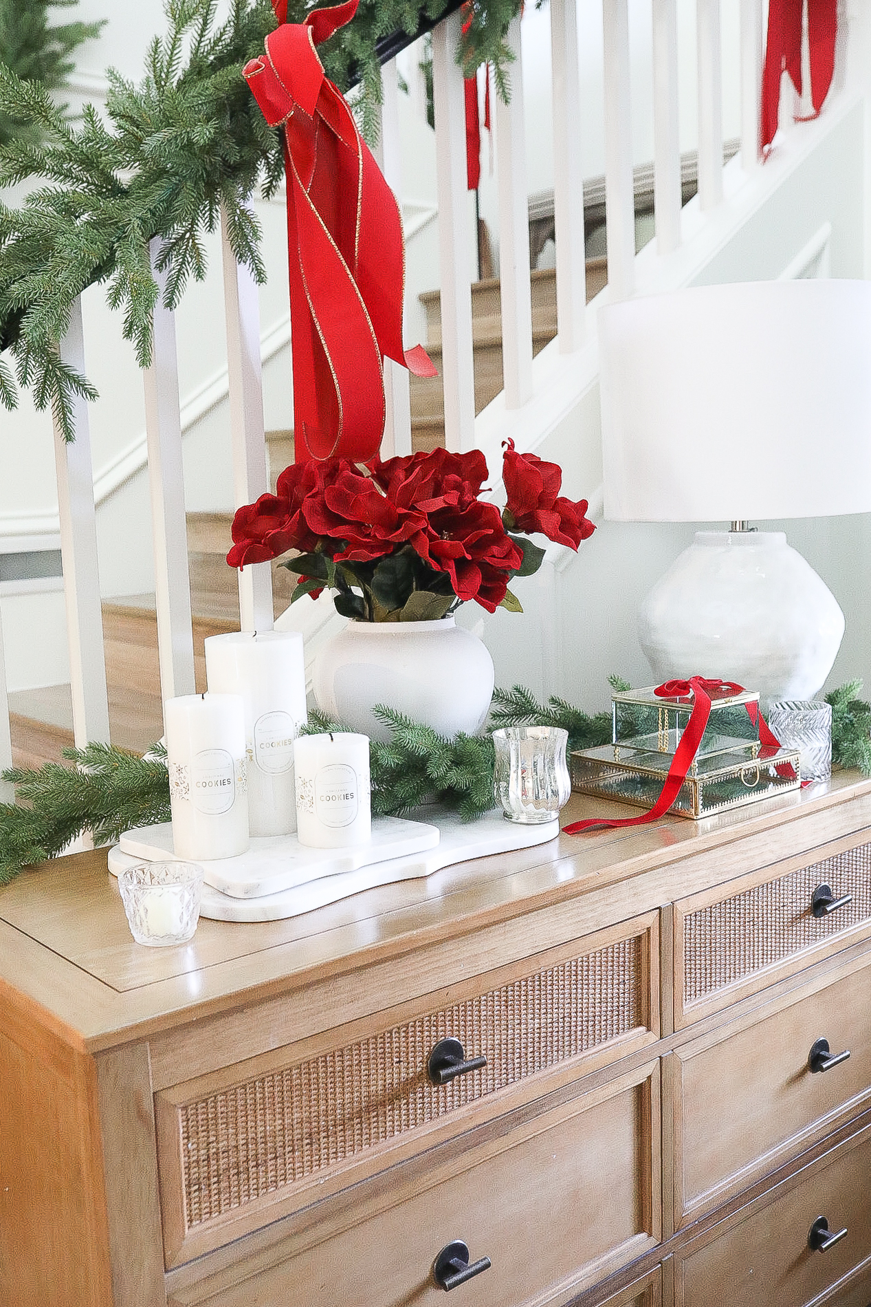 Entryway with red Christmas Decor on the entry table.