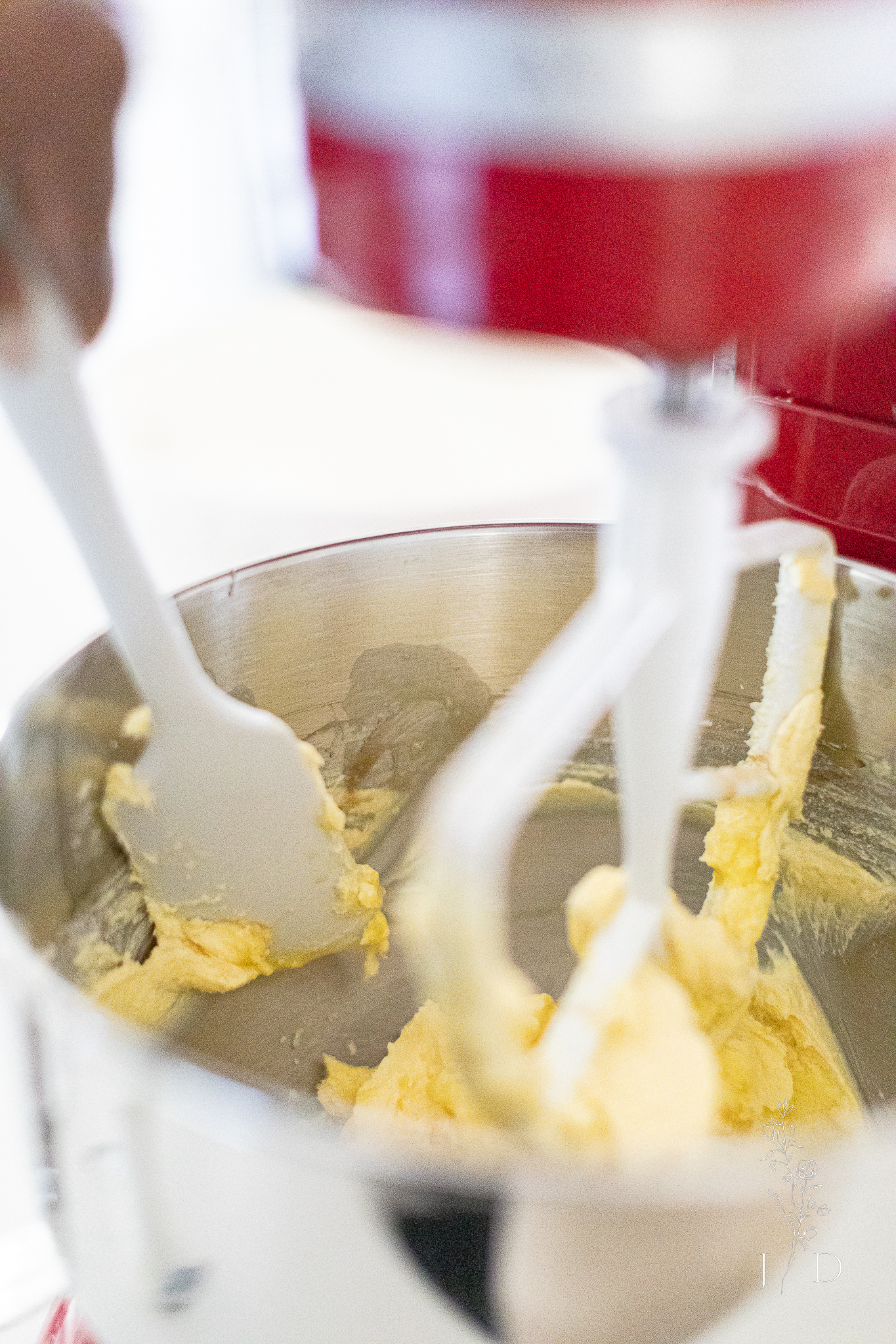 Scraping cookie dough down into bowl.