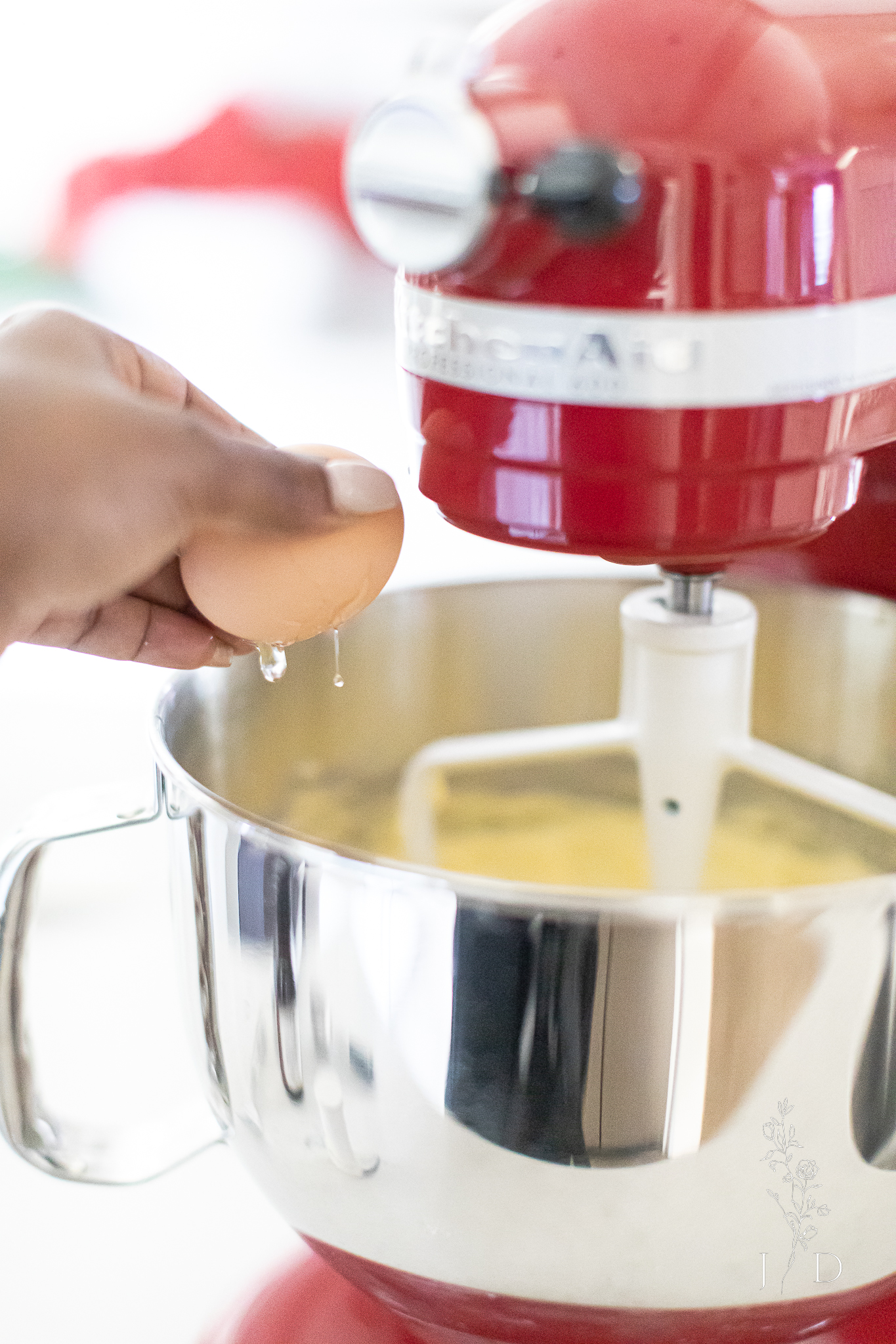 Cracking a egg and putting it into cookie mix for Mexican Christmas cookies