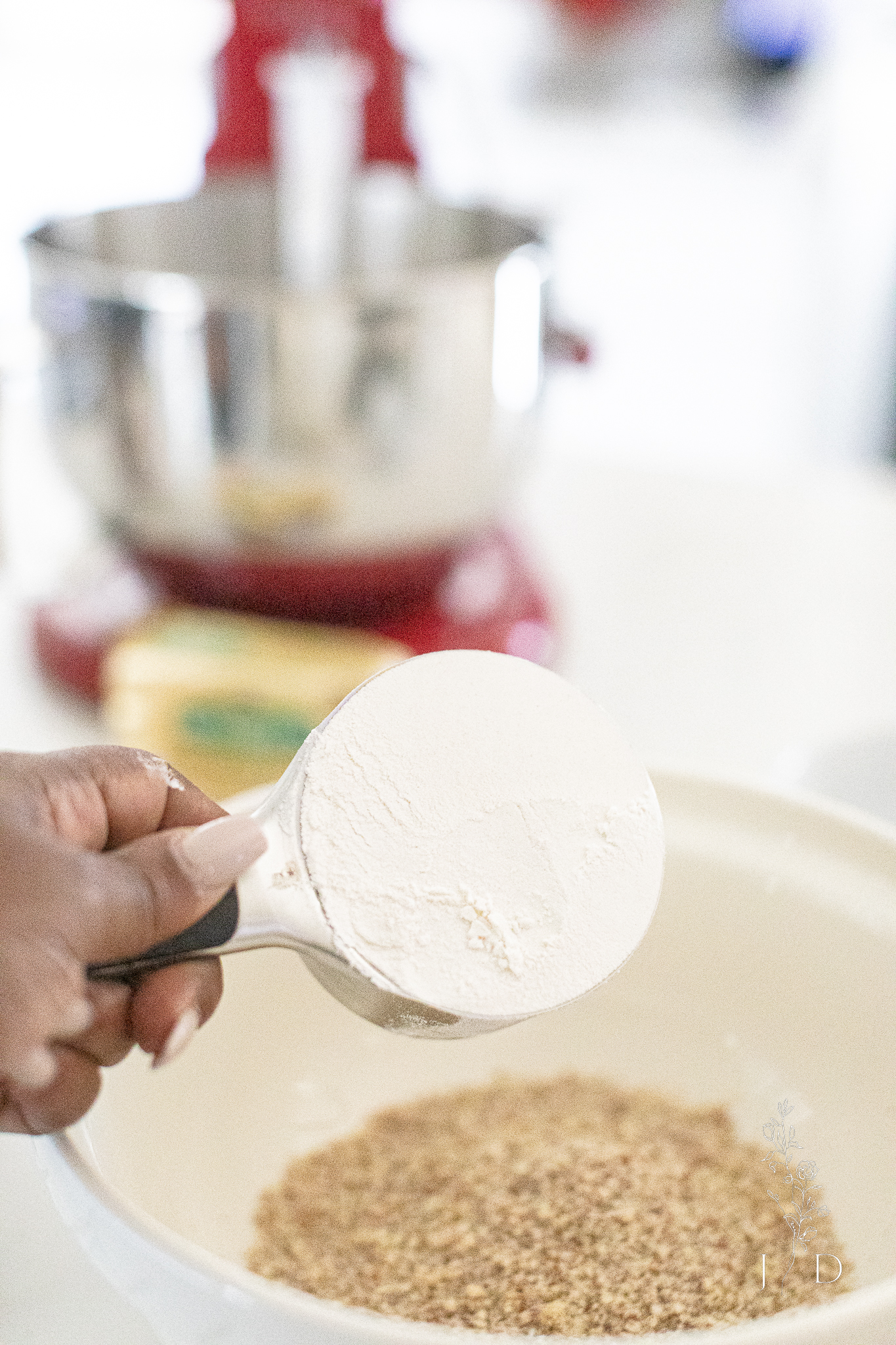 One cup of flour going into cookie dough mix. 