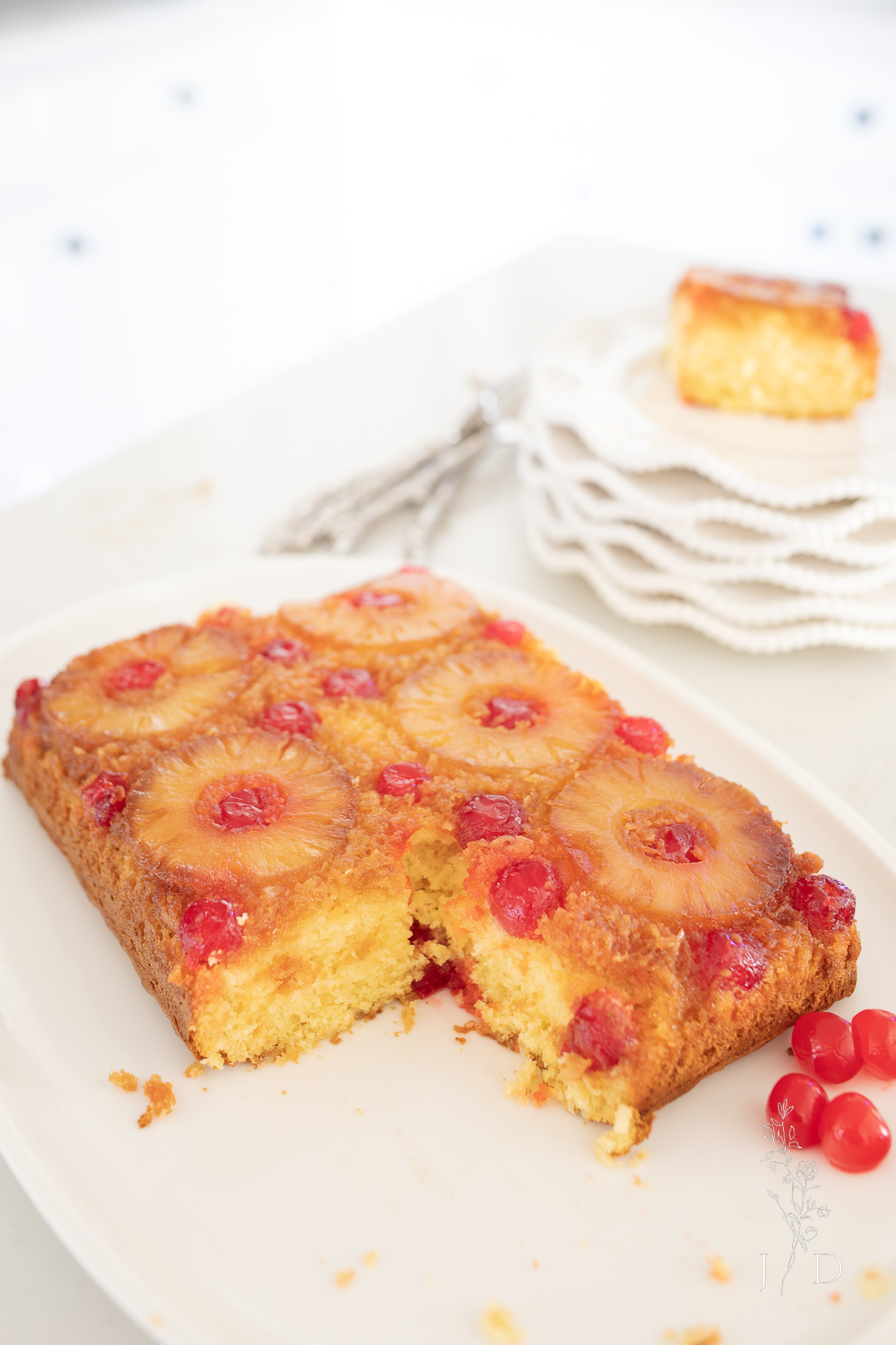 Shot of a pineapple upside down cake with a piece missing from the corner