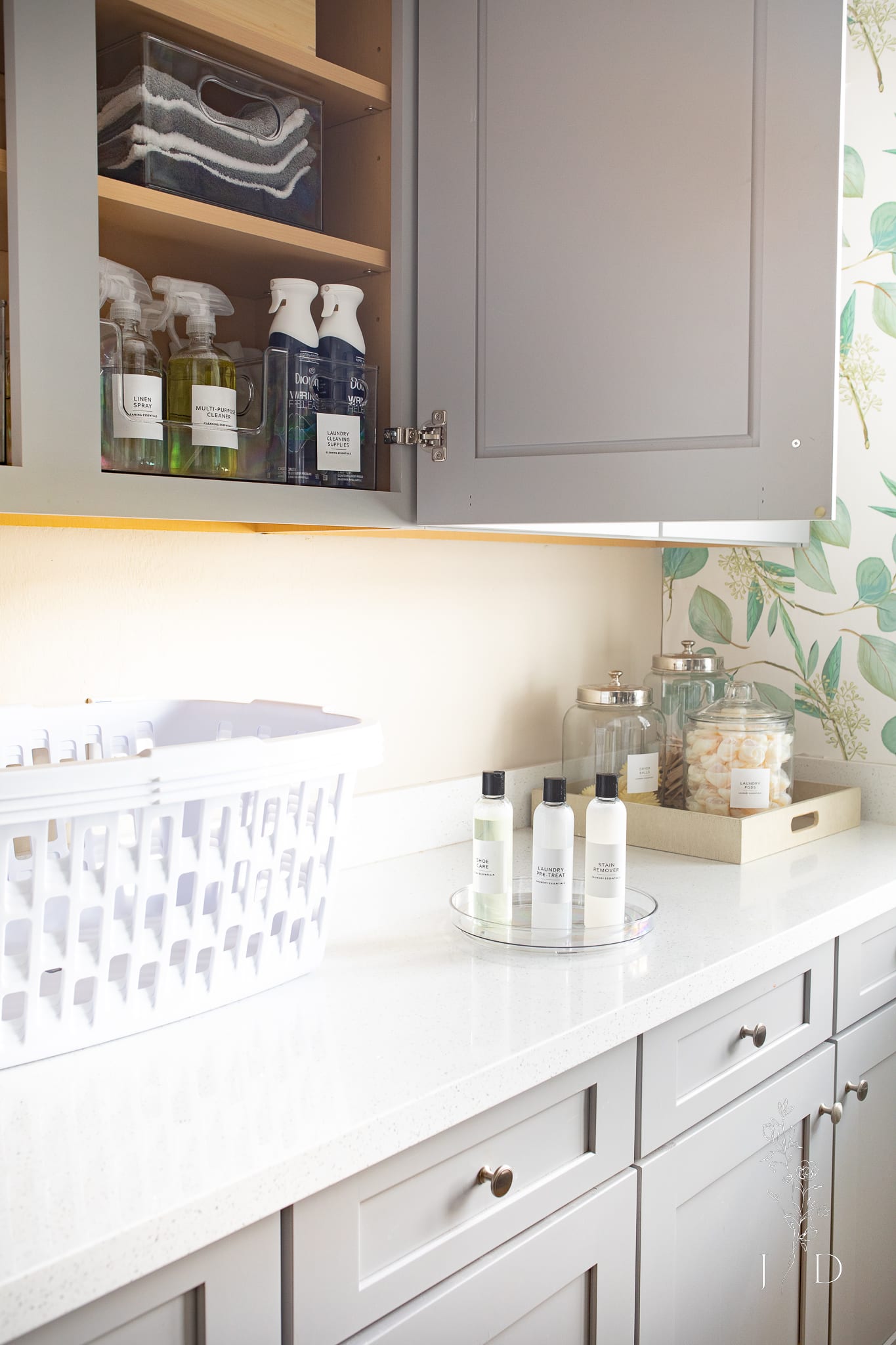 A gray organized laundry room with baskets and laundry essentials 
