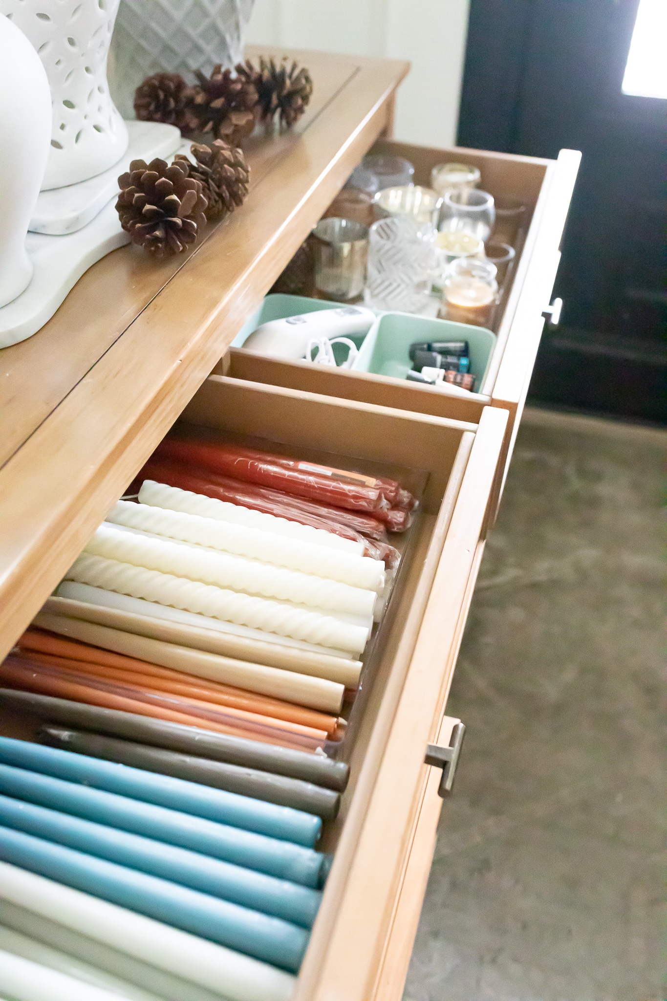 Organized tapered candles in a drawer. 
 