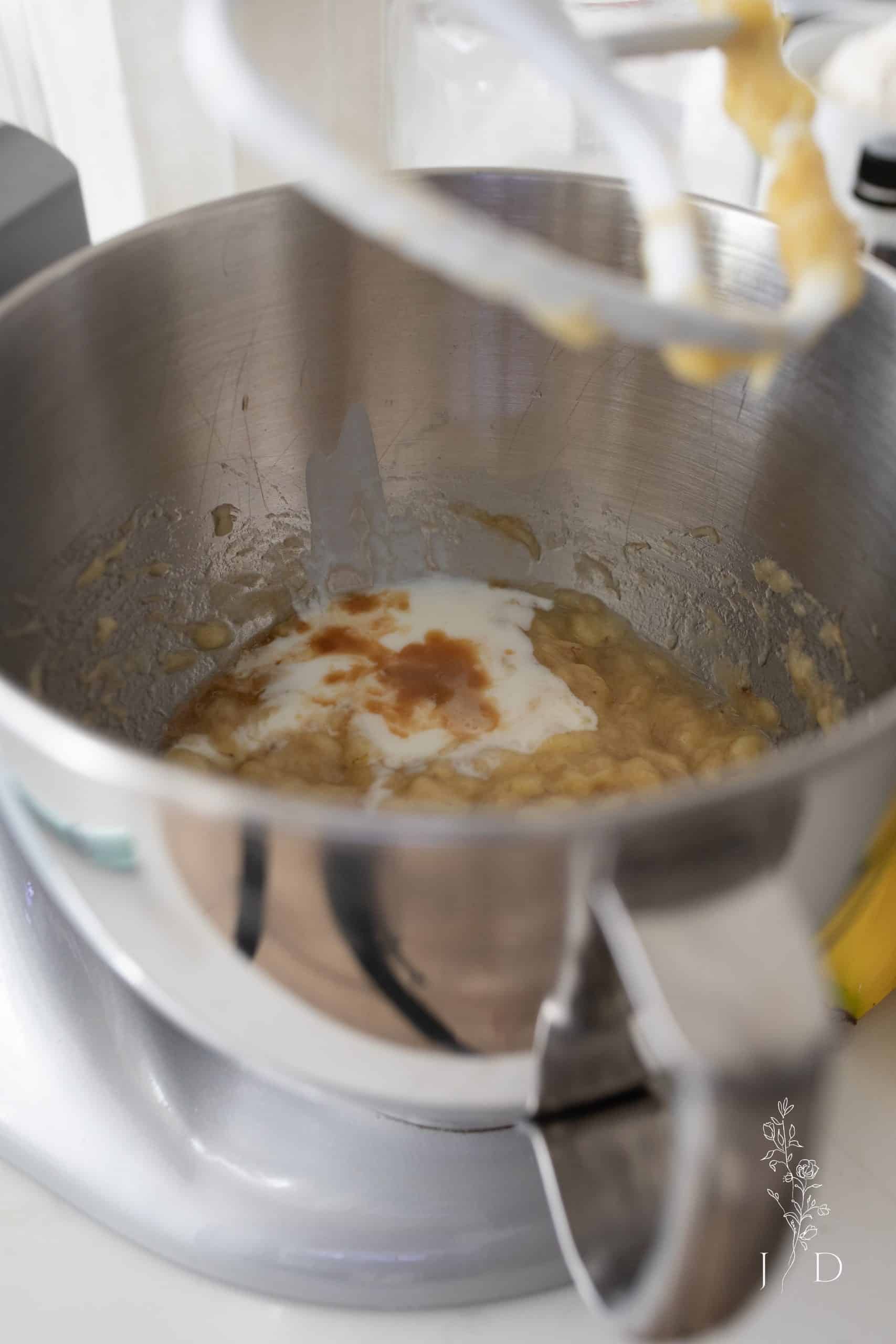 Mixing ingredients to make banana cake from scratch.
