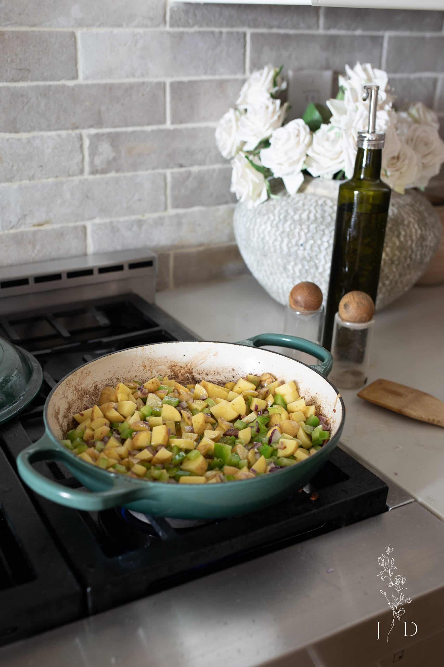 Potatoes, onion, peppers frying in a pot 